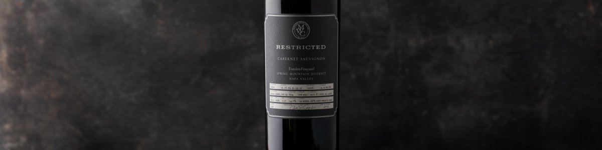 Single bottle of Restricted Cabernet against a dark background